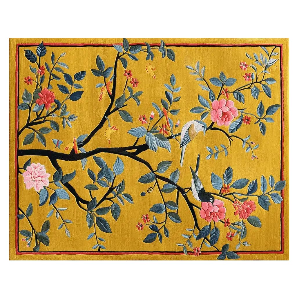 A vibrant area rug featuring a lively design of a cherry tree with colorful blossoms and birds, set against a rich yellow background. The intricate hand-tufted details bring a sense of nature and elegance to any room.