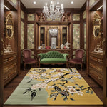 Decorative room with wooden furniture, a green sofa, and a floral rug.