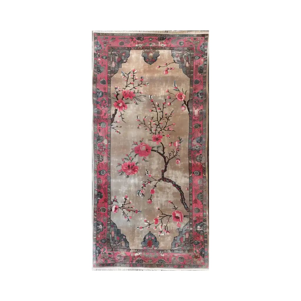 Elegant area rug featuring a vibrant floral design with pink blossoms and intricate branches on a soft beige background, bordered by a rich red and blue pattern.
