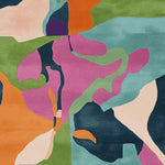 Vibrant abstract design on a hand-tufted area rug, featuring a mix of colorful shapes in orange, green, purple, and blue. Ideal as a contemporary square rug for living rooms, this wool rug adds a modern touch to any space.