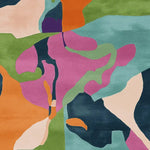 Vibrant abstract design on a hand-tufted area rug, featuring a mix of colorful shapes in orange, green, purple, and blue. Ideal as a contemporary square rug for living rooms, this wool rug adds a modern touch to any space.