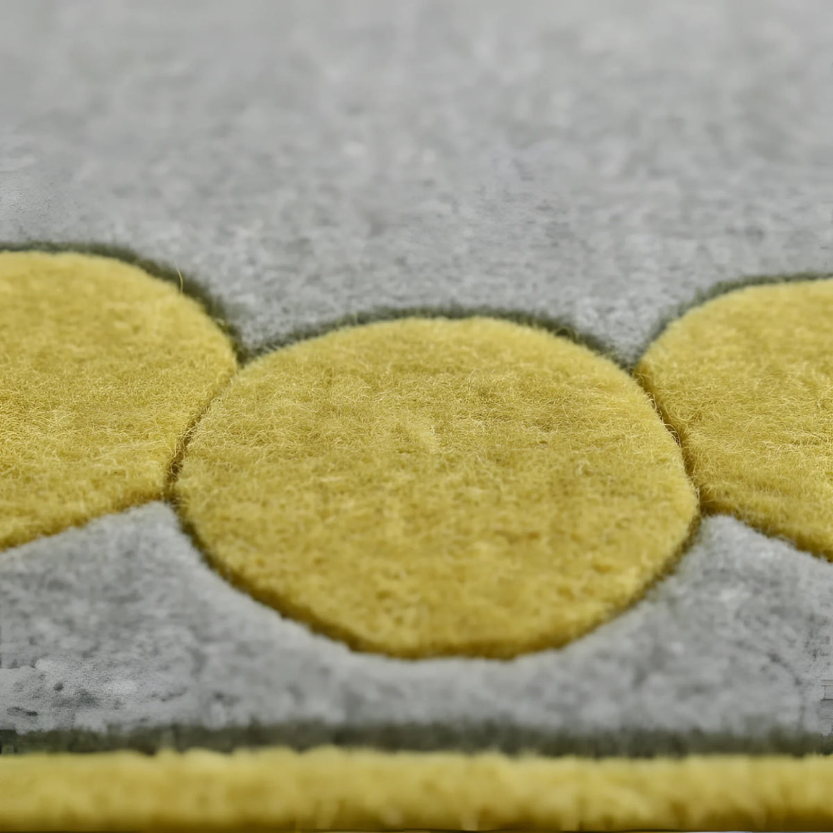 Gray rug with yellow circular patterns