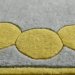 Gray rug with yellow circular patterns