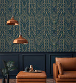 Cityscape glam wallpaper with gold Art Deco lines on navy above dark paneling, copper pendant lights, tan leather chair