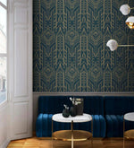 Cityscape glam wallpaper with gold Art Deco pattern on deep navy behind a curved navy velvet banquette and marble tables