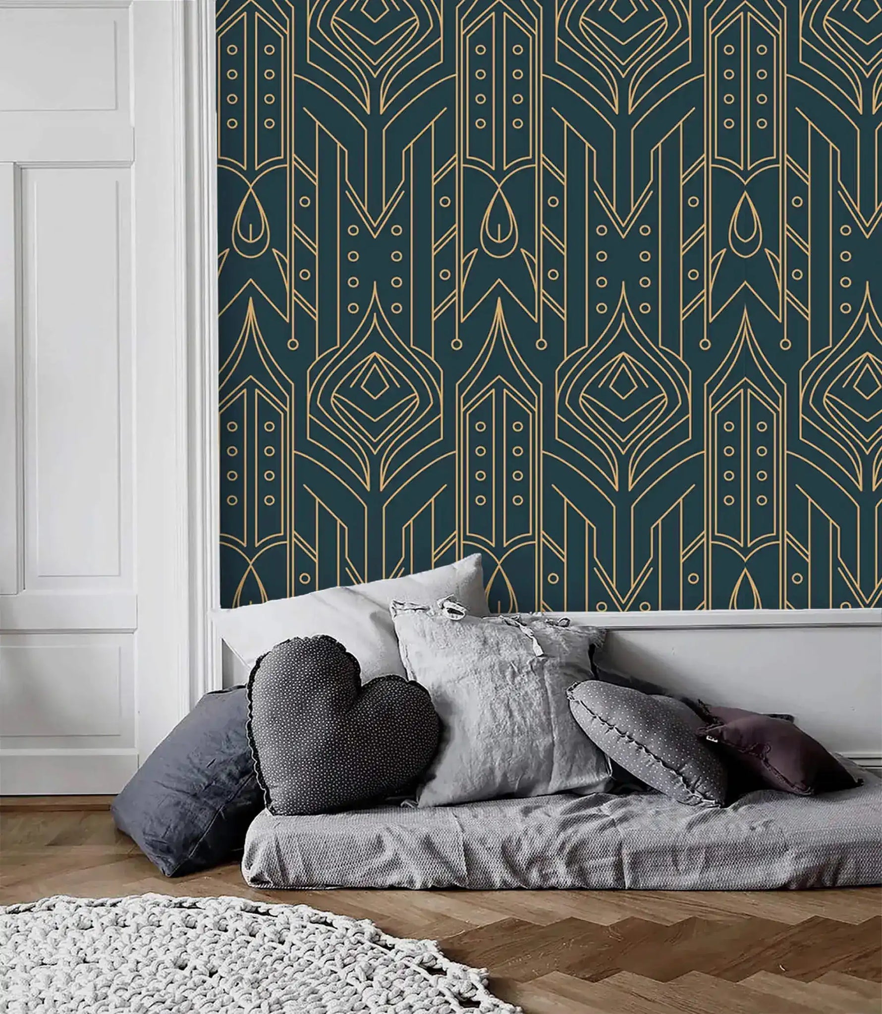 Cityscape glam wallpaper with gold geometric motifs on navy as accent panel beside a white molded wall, gray floor sofa