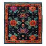 Vibrant hand-tufted wool area rug featuring a bold floral design with rich colors, perfect as a dining table rug in a dining room setting.