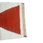 Close-up of the Classic Bow Moroccan Berber Handwoven Wool Area Rug in pink, showcasing its intricate design and texture. Ideal as a runner rug for kitchens, hallways, or bathrooms, this boho wool rug adds a touch of elegance and warmth to any space.