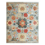 This Classic Charm Hand Tufted Rug features an intricate floral pattern in vibrant red, orange, and blue tones on a soft, elegant background. Ideal for adding a touch of sophistication to your office or dining room, this wool area rug combines style and comfort, making it a perfect choice for office rugs or rugs for office settings.