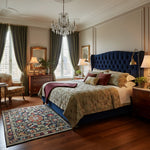 Luxurious bedroom with a large bed, decorative pillows, a floral traditional hand-tufted wool rug, and a chandelier.