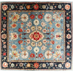 Beautifully detailed Classic Flower Vine Hand Knotted Area Rug, featuring an intricate Persian design with vibrant florals and vines on a soft blue background. Perfect for adding elegance to a dining room or living room, this wool rug embodies timeless charm and luxury.