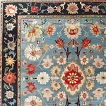 Beautifully detailed Classic Flower Vine Hand Knotted Area Rug, showcasing intricate floral patterns with vibrant colors on a blue background. Ideal for adding a touch of elegance to your dining room or living room. This wool rug embodies the timeless allure of Persian rugs, perfect as a dining room area rug.