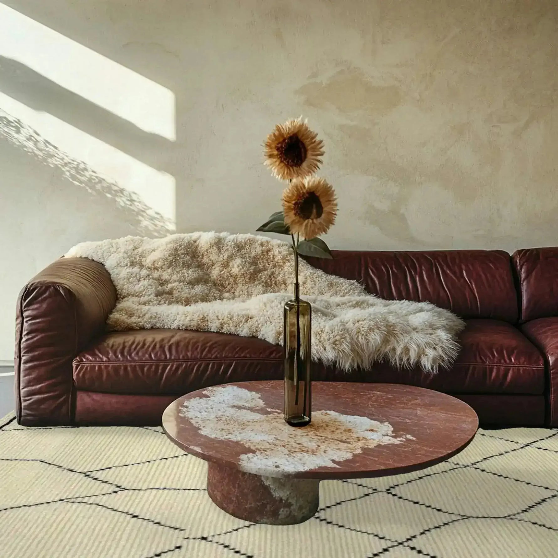A stylish living room featuring a Classic Moroccan Hand Spun Wool Hand Knotted Area Rug, perfect for adding warmth and elegance. This 8x10 living room area rug complements the cozy leather sofa and round coffee table, creating an inviting atmosphere.