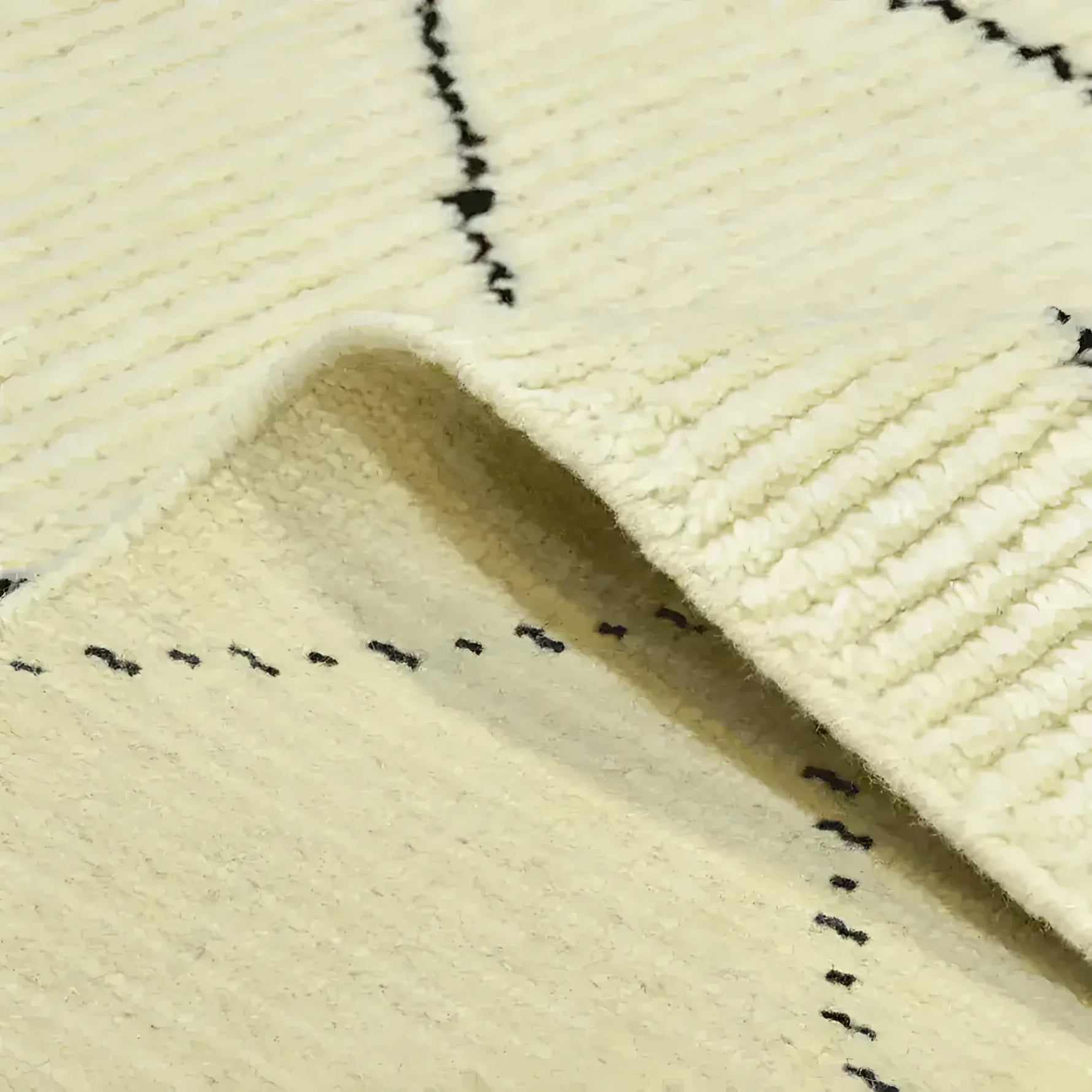 Close-up view of a Classic Moroccan Hand Spun Wool Hand Knotted Area Rug showcasing intricate black line patterns on a cream background. Ideal for adding a touch of elegance to living room area rugs, perfect in an 8x10 size.