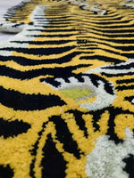 Close-up view of the Classic Tiger Yogi Accent Wool Rug, showcasing its bold black and yellow tiger stripe pattern. This area rug is perfect for adding a touch of wild elegance to any office or bedroom setting.