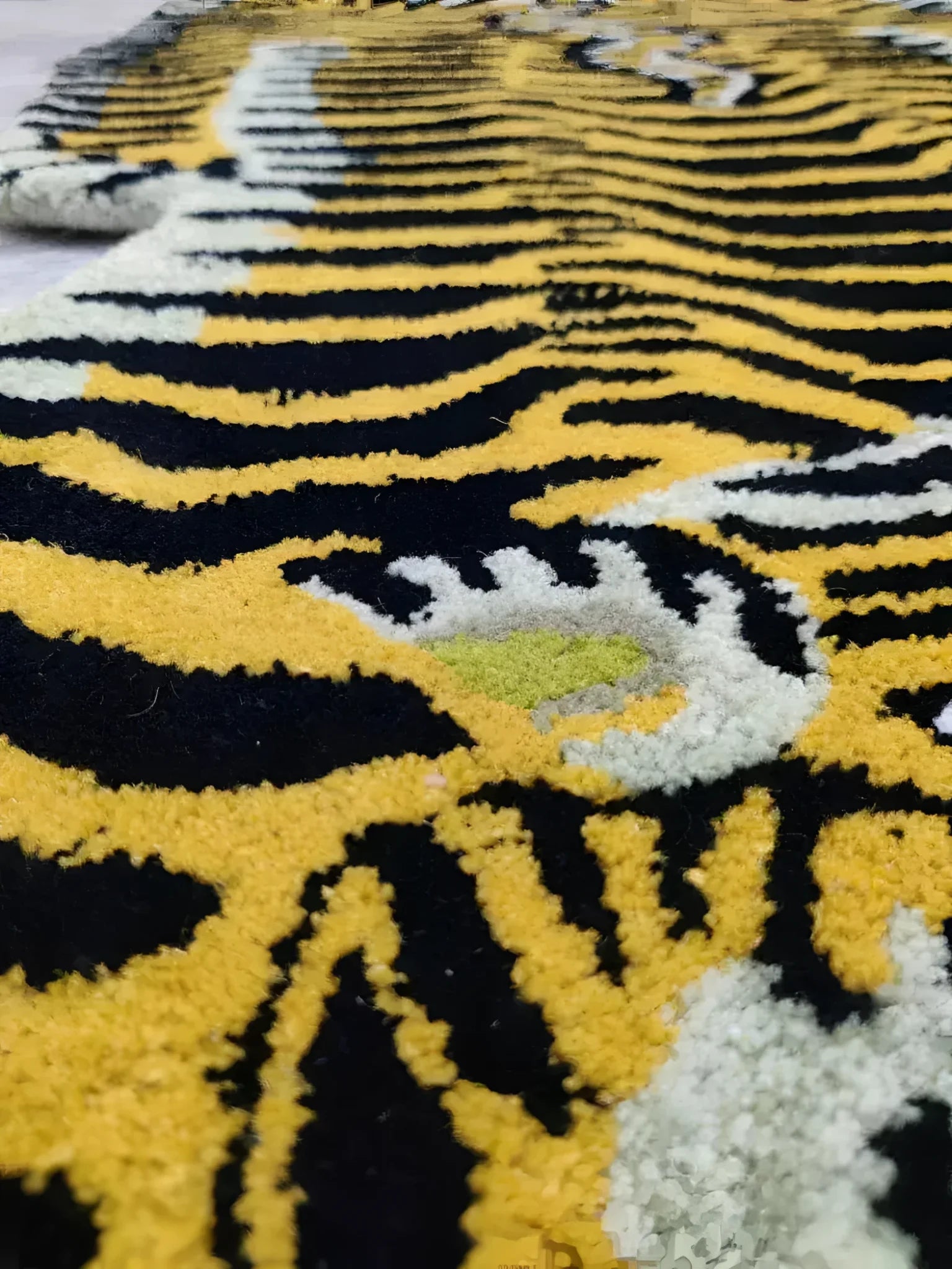 Close-up view of the Classic Tiger Yogi Accent Wool Rug, showcasing its bold black and yellow tiger stripe pattern. This area rug is perfect for adding a touch of wild elegance to any office or bedroom setting.