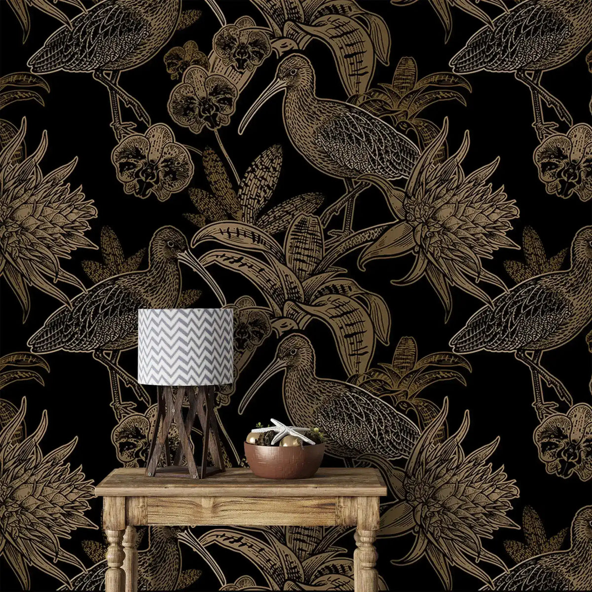 Close-up black and gold wallpaper with line-art birds and orchids behind rustic table with chevron lamp