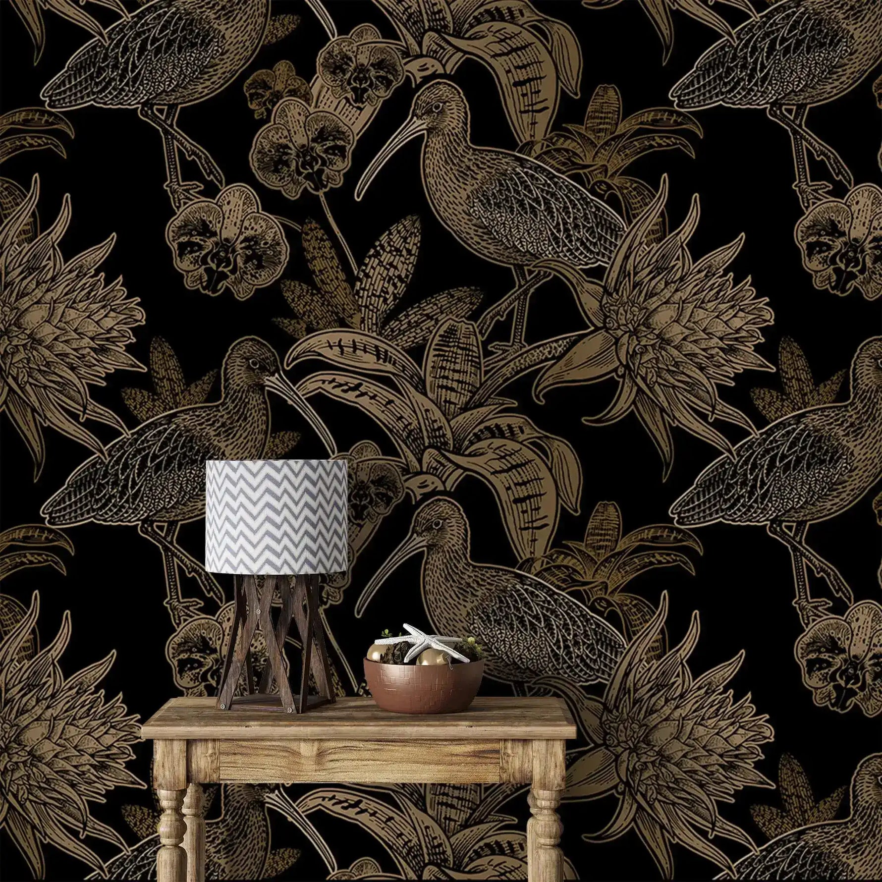 Close-up black and gold wallpaper with line-art birds and orchids behind rustic table with chevron lamp