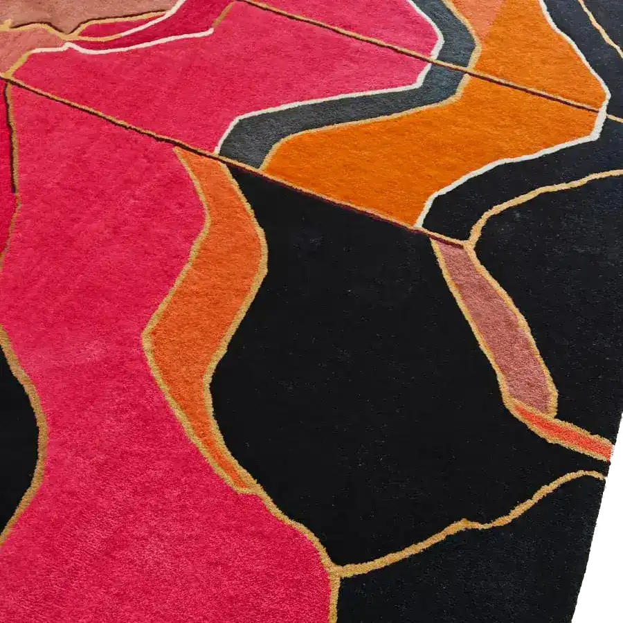 Close-up of Abstract Grandeur rug pile, plush pink, orange and black waves edged in gold