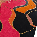 Close-up of Abstract Grandeur rug pile, plush pink, orange and black waves edged in gold