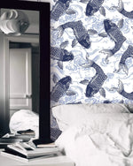 Close-up of indigo koi swimming through waves on Koi Pond Serenity wallpaper beside a mirror