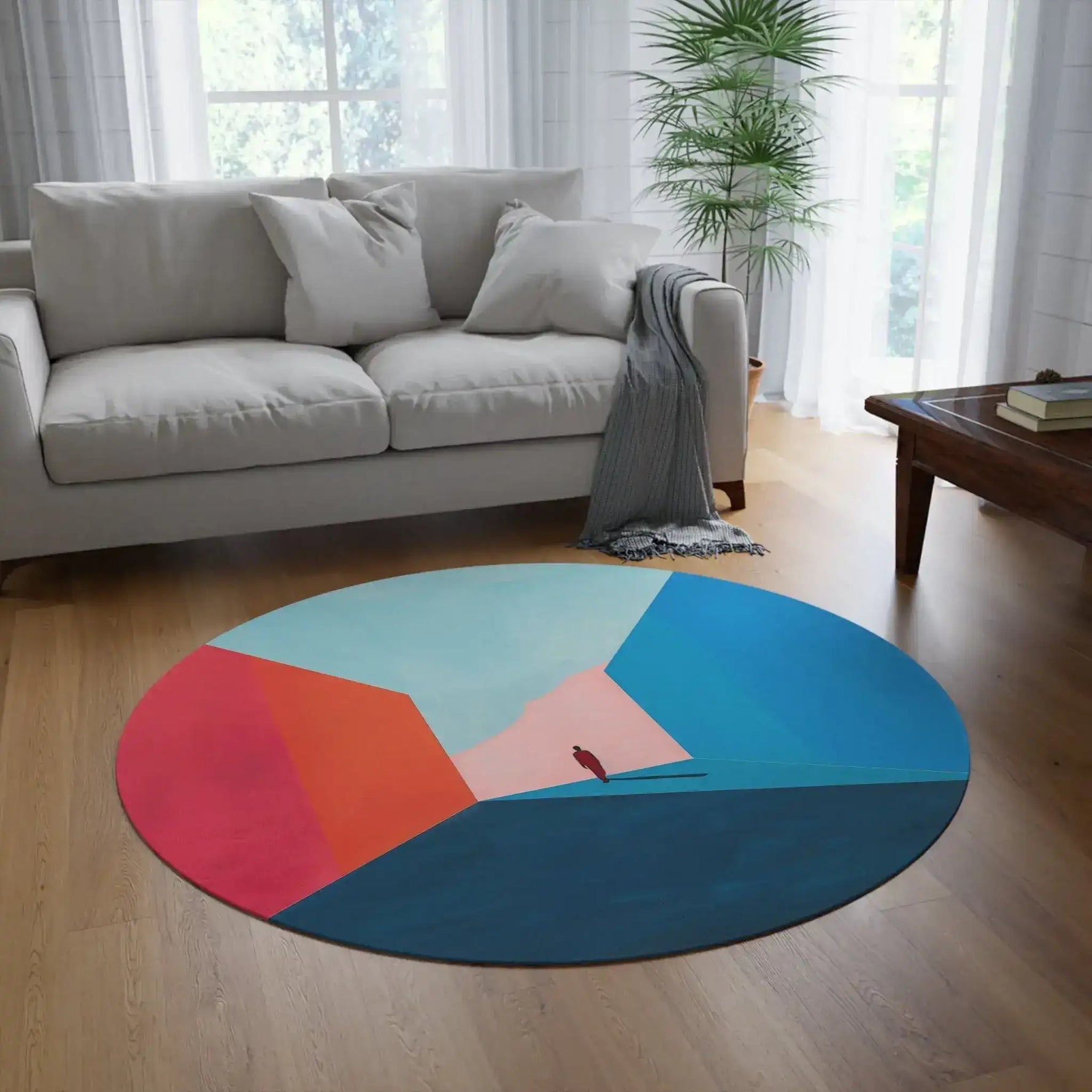 round color-block abstract rug in white living room with sofa and potted plant
