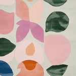 A vibrant, hand-tufted area rug featuring a contemporary design with abstract floral patterns in soft pinks, greens, and oranges. Perfect for adding a splash of color to living room spaces, this wool rug offers both comfort and style.