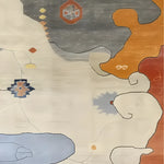 Top view of a Color Cascade Hand Tufted Rug, showcasing an abstract design with earthy tones of gray, orange, and beige. Ideal for adding a touch of modern art to your bedroom or living room, this wool area rug seamlessly blends style and comfort.