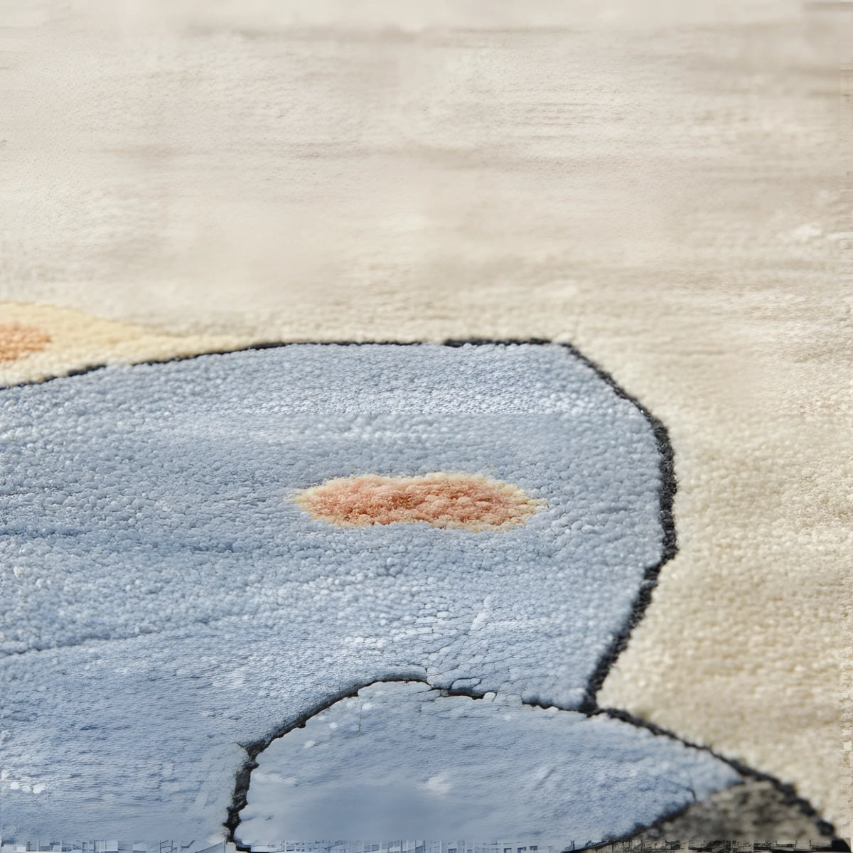 Close-up of a textured rug with a blue abstract design on a beige background