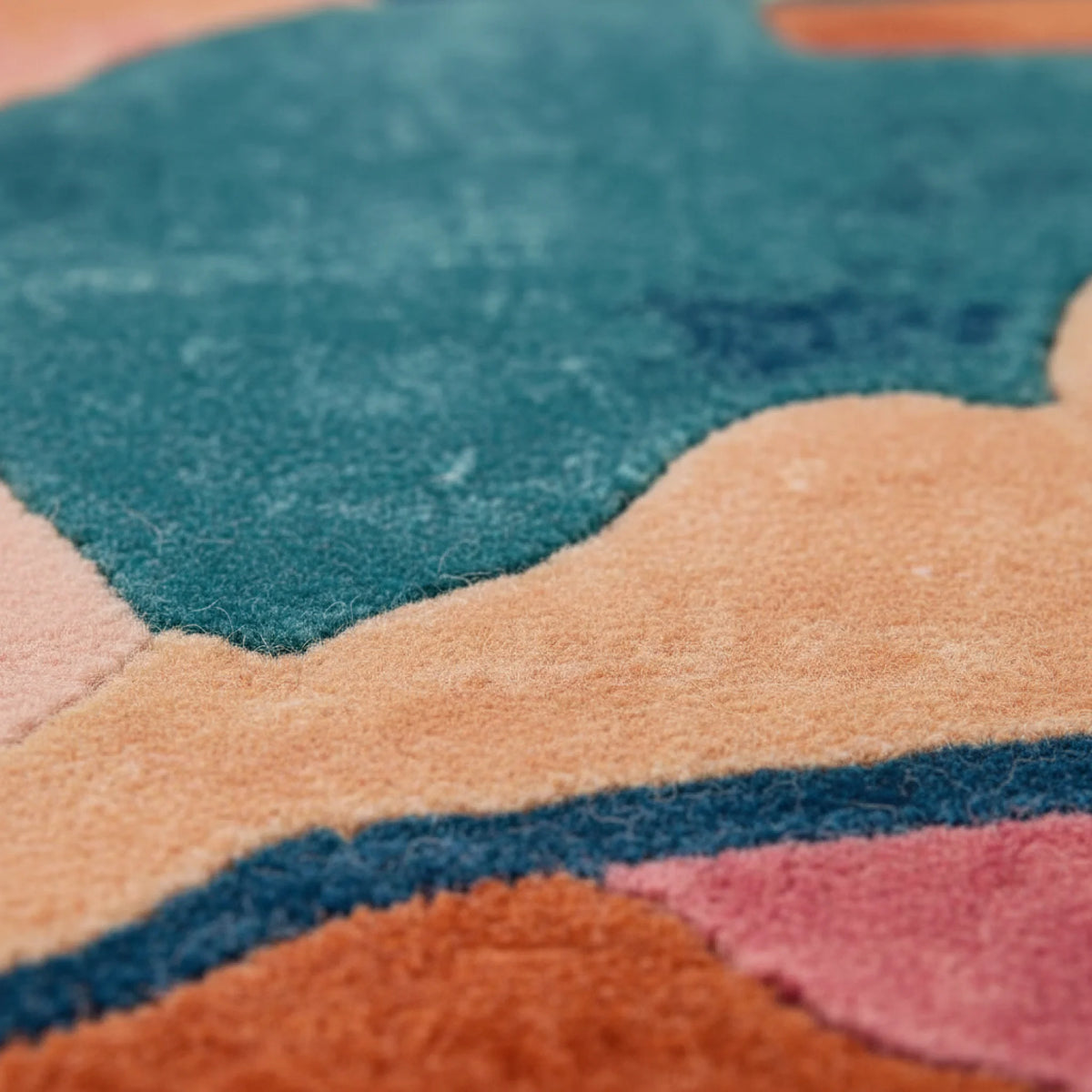 Close-up of a textured multicolored rug with geometric patterns.