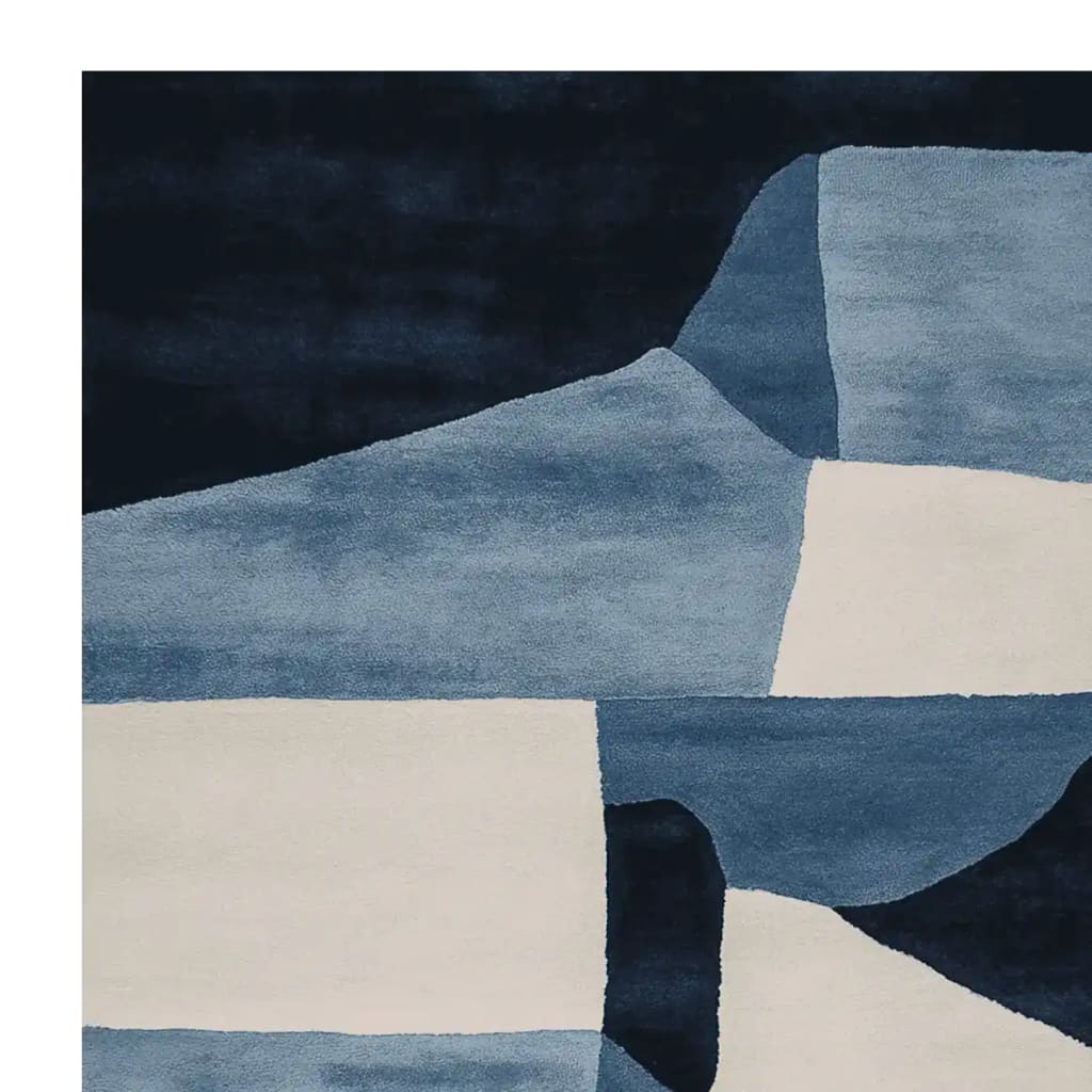 A stunning hand-tufted area rug featuring an abstract design in shades of blue and cream. This contemporary wool rug is perfect for adding a modern touch to living room spaces. The intricate patterns and rich colors make it an ideal choice for those seeking stylish living room area rugs.