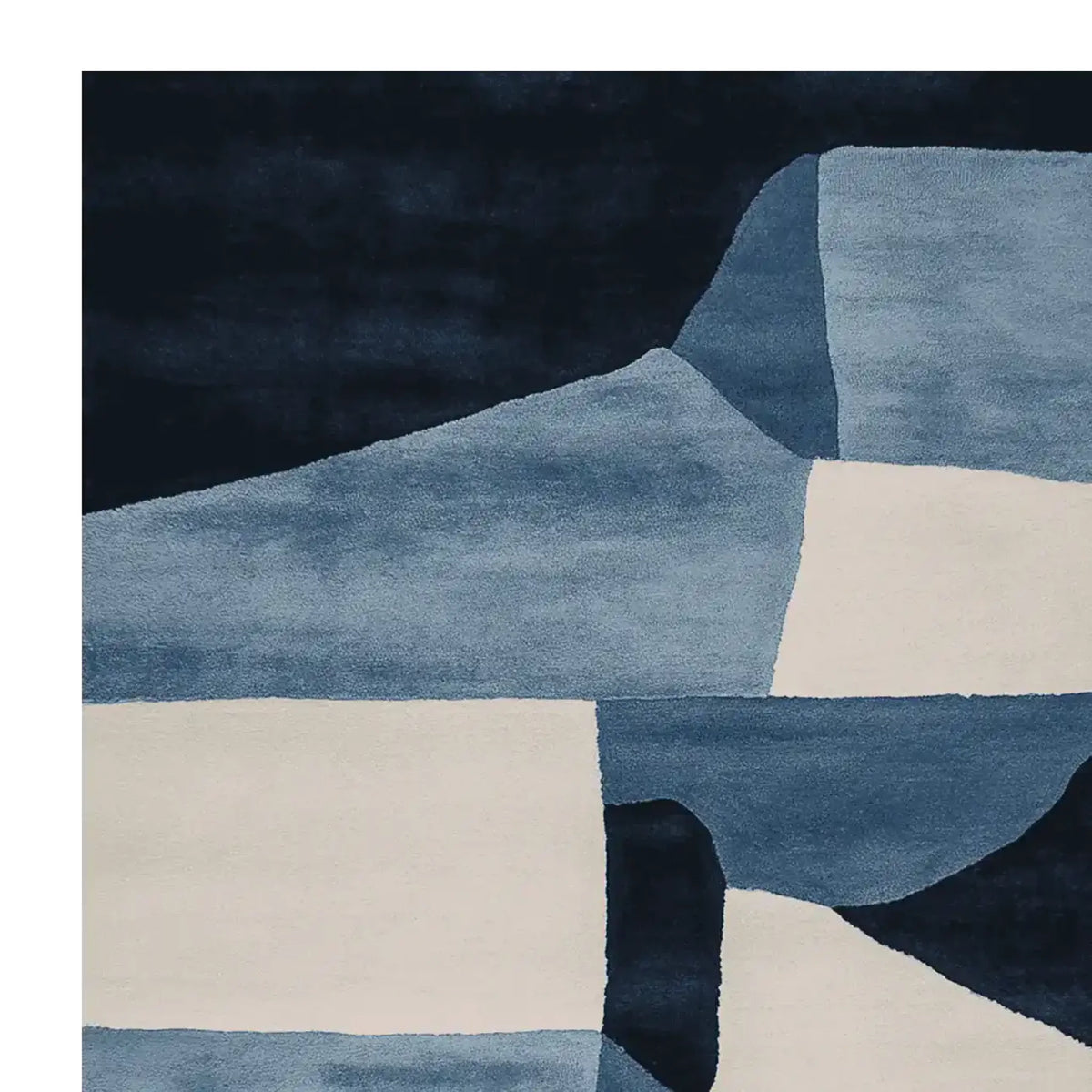 A stunning hand-tufted area rug featuring an abstract design in shades of blue and cream. This contemporary wool rug is perfect for adding a modern touch to living room spaces. The intricate patterns and rich colors make it an ideal choice for those seeking stylish living room area rugs.