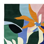 Vibrant Color Mirage Flora Hand Tufted Area Rug featuring a contemporary abstract floral design. This wool rug, perfect for enhancing living room aesthetics, showcases bold colors including orange, pink, blue, and green.