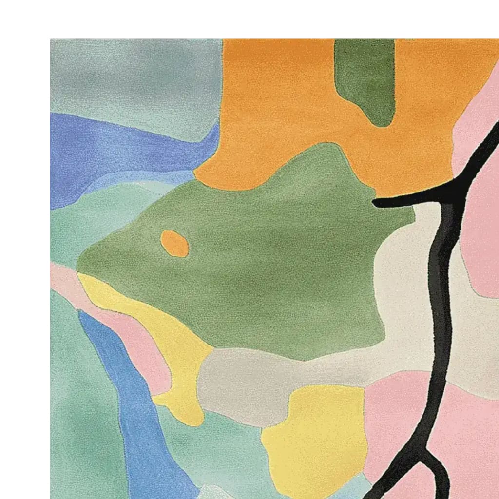 Top view of a colorful, abstract area rug featuring bold patches of orange, green, blue, and pink, perfect for adding a contemporary touch to your living room. This wool rug combines vibrant hues in a modern design, making it an ideal choice for those seeking unique area rugs for living room spaces.