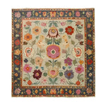 A luxurious living room featuring a Colorful Canopy Hand Knotted Area Rug with vibrant floral patterns. This vintage Persian-inspired rug adds a touch of elegance, making it an ideal choice for area rugs in the living room. The room is adorned with a classic chandelier, plush sofas, and framed artwork, creating a harmonious blend of style and comfort.