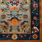Vibrant and intricate design of a Colorful Carnival Hand Tufted Wool Rug, showcasing a rich tapestry of floral and abstract patterns. This large area rug is perfect for adding a touch of elegance to any living room, with its bold colors and detailed craftsmanship. Ideal for those seeking unique area rugs for living room spaces.