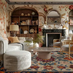 Luxurious living room with floral handmade rug, wallpaper, bookshelves, and a fireplace.