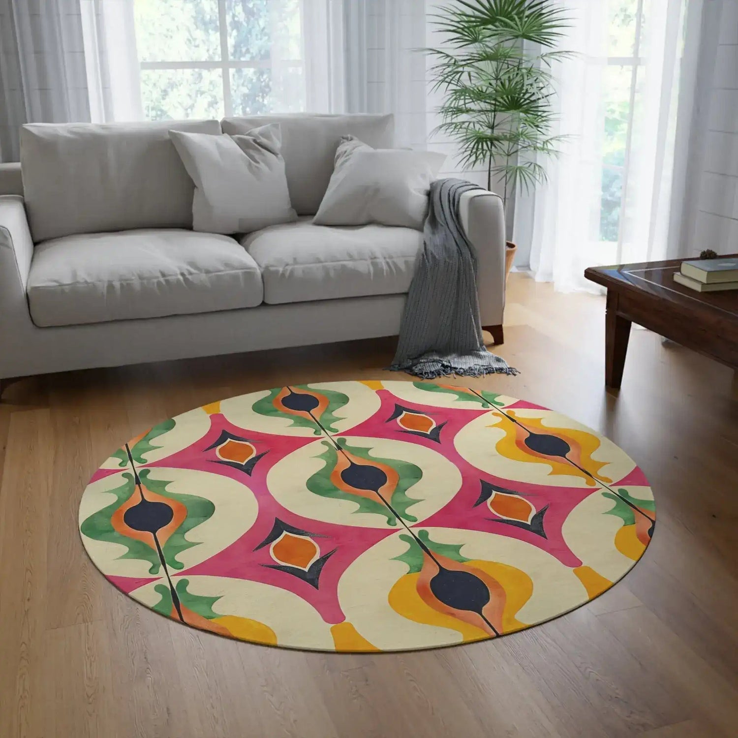 Colorful Retro Geometric Pattern Round Rug with 70s-style ogee shapes in pink, green, orange and yellow, styled in a light-filled living room