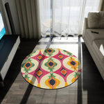 Colorful Retro Geometric Pattern Round Rug with bold ogee shapes in pink, yellow, green and orange placed in a dark modern living room with balcony light