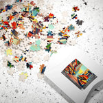 Colorful Urban Vibes puzzle pieces scattered across speckled surface beside white product box