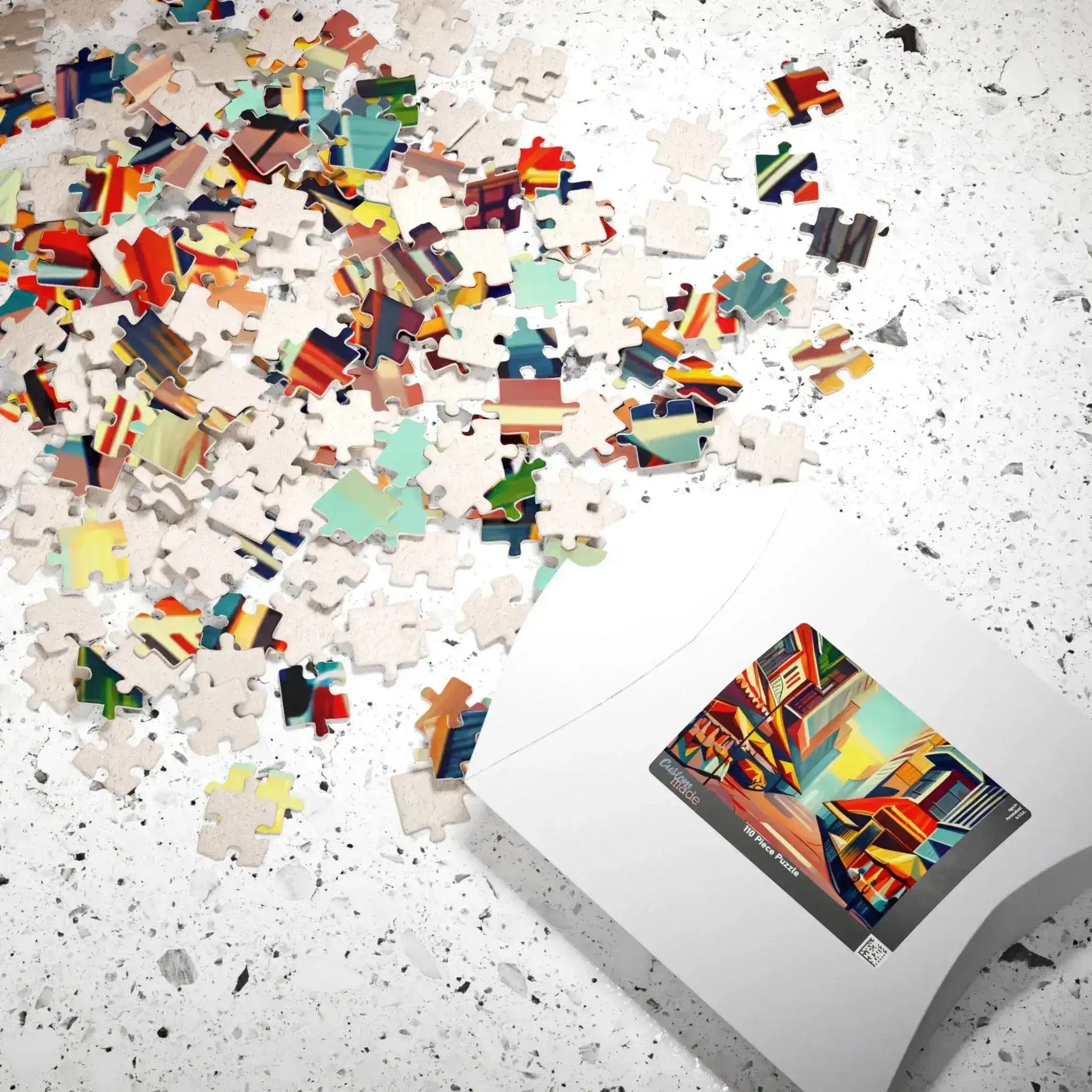 Colorful Urban Vibes puzzle pieces scattered across speckled surface beside white product box