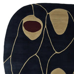 This is a top view of a contemporary area rug featuring a bold abstract design. The hand-tufted wool rug displays a striking pattern with organic shapes in contrasting colors, ideal for large living room spaces. Perfect for adding a modern touch to any space, this rug is a standout piece among rugs for living rooms.