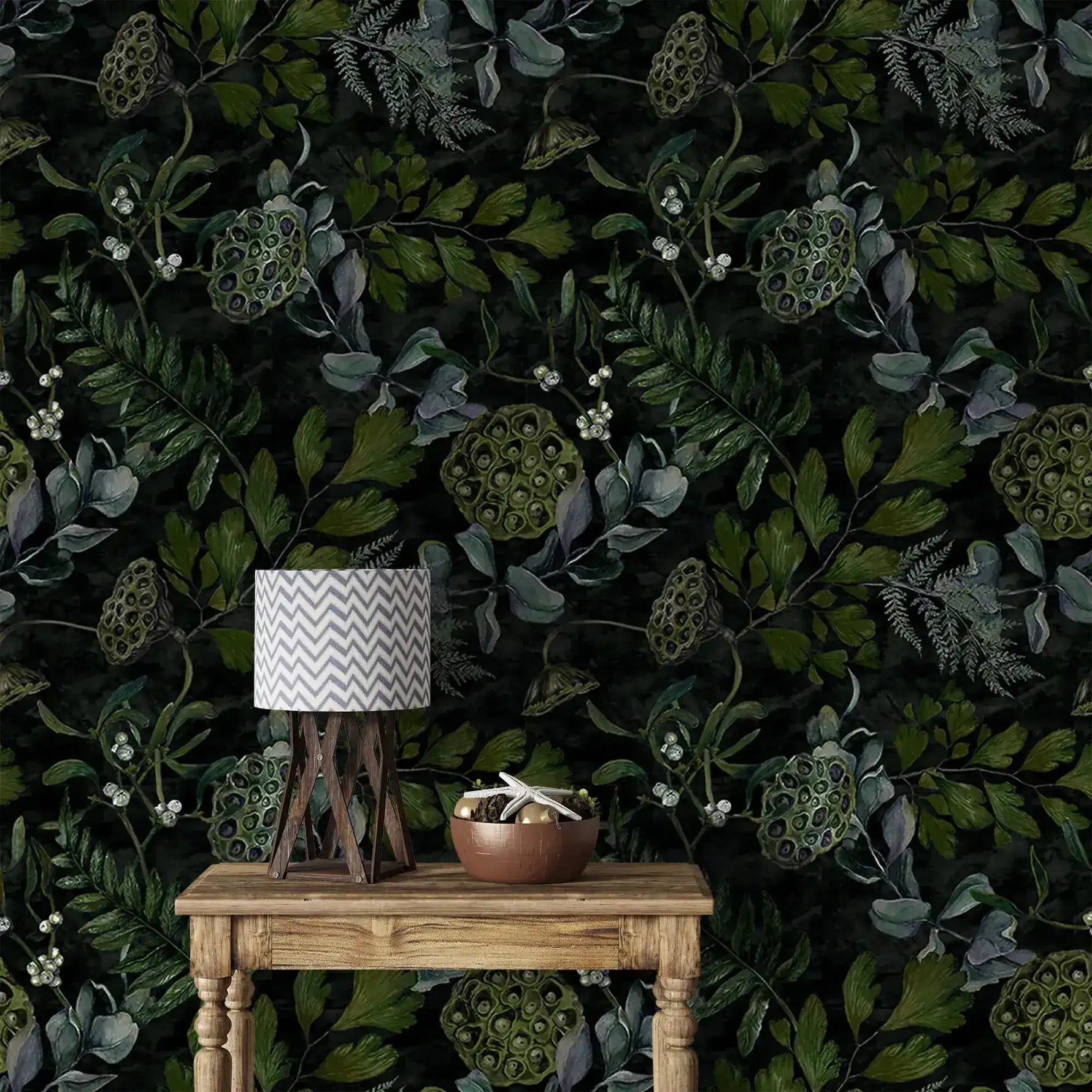 Console with chevron lamp against enigmatic leafy canopy wallpaper, dark greenery and seed pods