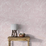 Console with chevron lamp against pink floral sketch wallpaper, white outlined flowers on pink