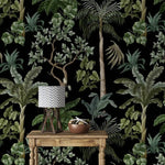 Console with chevron lamp and bowl against jungle foliage wallpaper of palms and trees
