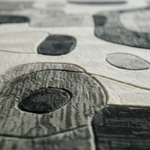 Close-up of interlocking stone pavers with circular patterns rug