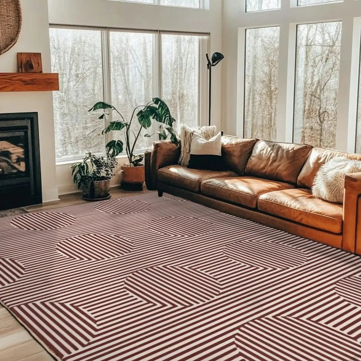 A stylish living room featuring a Contemporary Eclipse Illusion Hand Tufted Wool Rug in red. This large area rug, perfect for living room settings, showcases an eye-catching geometric pattern, complementing the cozy leather sofa and modern decor. Ideal for those seeking trendy wool rugs to enhance their living space.