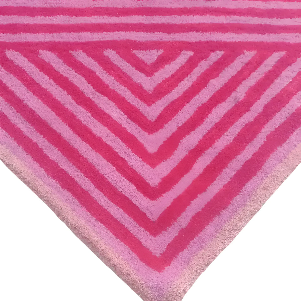 A vibrant hot pink geometric hand-tufted wool area rug, perfect for enhancing large living room spaces or dining room settings. The design features bold V-shaped stripes that converge at the corner, adding a contemporary flair to any interior decor.