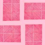 A vibrant contemporary hot pink geometric area rug, perfect for large living room rugs or dining room carpets. The hand-tufted wool rug features intricate square and triangular patterns, adding a modern touch to any dining room or living room setting.