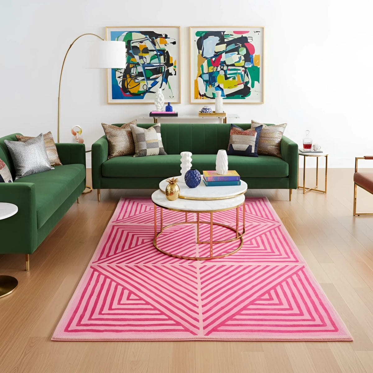 Modern living room with green sofas, a pink geometric rug, and abstract art on the wall.
